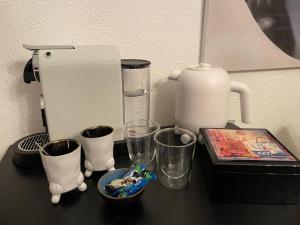 a counter with a coffee maker and cups on it at In de Steenstraat in Zwolle