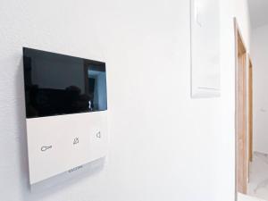 a flat screen tv on a white wall at 268 Leipzig Plagwitz Apartment Kulturviertel in Leipzig