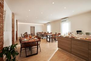 a large dining room with tables and chairs at Brussa Horse Oasi in Caorle