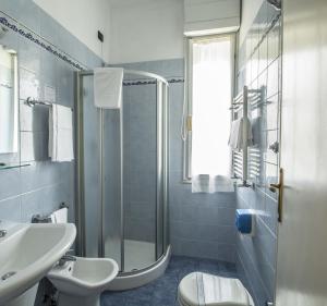 a bathroom with a sink toilet and a shower at Hotel Riviera Blu in Tirrenia