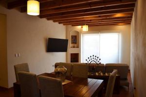 a dining room with a table and chairs and a window at Beautiful home w/Pool @Capilla de Piedra in San Miguel de Allende