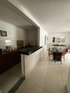 a kitchen and dining room with a table and chairs at Hangar House in Belém