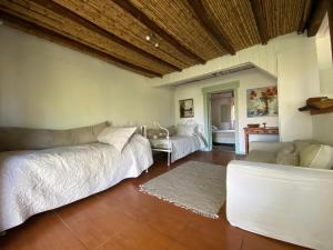 a living room with two beds and a couch at Uva Dulce in Tunca Arriba