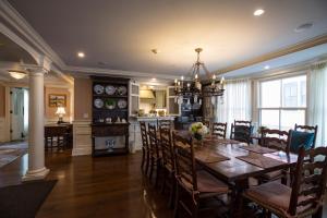 a dining room and kitchen with a table and chairs at Saybrook Point Resort & Marina in Old Saybrook