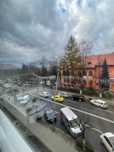 a view of a parking lot with cars on a street at Garsonieră Ultracentrală Petroșani Valea Jiului in Petroşani