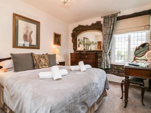 a bedroom with a large bed and a mirror at Tythe Barn House in Ilfracombe