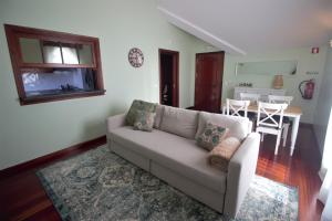 a living room with a couch and a table at Rose Velvet in Angra do Heroísmo