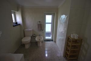 a bathroom with a toilet and a sink and a shower at Rose Velvet in Angra do Heroísmo +26 photos