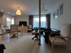 a living room with a couch and a table and chairs at agro NOCLEGI in Nagawczyna