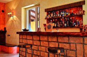 a bar with two stools and a brick wall at Dreams Valley in Valmontone +91 photos