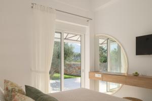 un soggiorno con un grande specchio e un letto di pelagias villa lefka with heated pool a Mathés