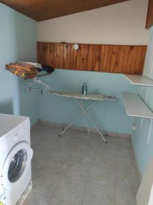 een wasruimte met een wastafel en een wasmachine bij Chez Axel in Le Marin