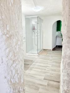 a bathroom with a shower and a tile floor at Apartamentos La Cueva in Paterna