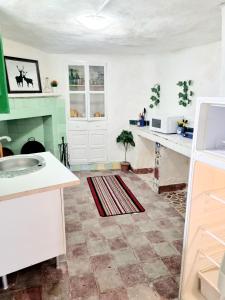a kitchen with a sink and a counter top at Apartamentos La Cueva in Paterna