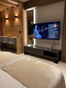 a bedroom with a flat screen tv on the wall at Apartman Kopaonik Woodside 106 in Kopaonik