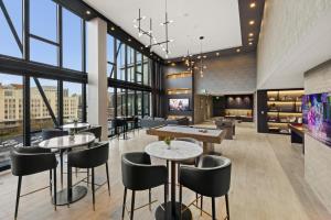 a restaurant with tables and ping pong tables at Global Luxury Suites at Capitol Hill in Washington, D.C.