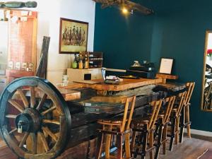 a bar with a wooden wheel in a room at Klaarstroom Hotel in Klaarstroom +23 photos