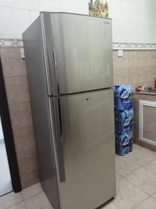 a stainless steel refrigerator in a kitchen at Muscat Homestay & Hospitality in Muscat