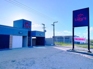 a building with a sign for a law firm at Lotus Motel Guaribas in Arapiraca