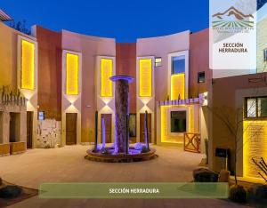 a building with a fountain in the middle of a courtyard at Hotel Boutique Valle de Guadalupe & Spa in Valle de Guadalupe +71 photos