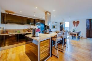 a kitchen with a counter and a dining room at Spacious 3-Bed Penthouse with City Sky Line Views in Sheffield