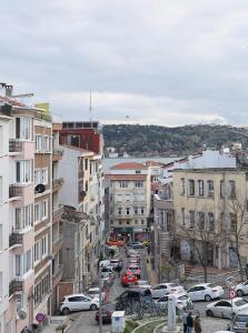 a city with cars parked on a street with buildings at Ortakoy Aysem Sultan Hotel in Istanbul