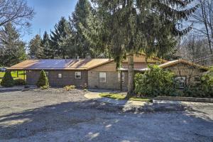 a house with a tree in front of it at Near Mines and Meadows Spacious Home with Game Room in Beaver Falls