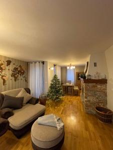 a living room with a christmas tree and a couch at Remarkable home Bohinj Lake in Bohinj