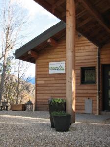 a building with a sign on the side of it at Chalet de l'Infernet in Auris