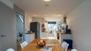 a kitchen with a table with a bowl of fruit on it at London Bridge 3 Bedroom House with reception room, office and private garden in London