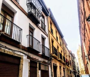 a building with balconies on the side of it at Suites BERRUETA (Plaza Mayor) in León