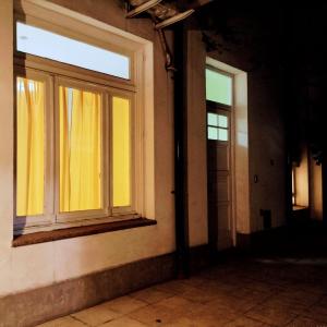 an empty room with two windows in a building at Departamento proximo al microcentro in Buenos Aires