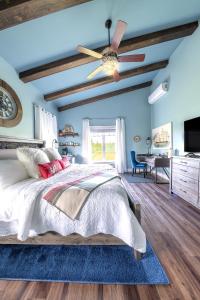 a bedroom with a bed and a ceiling fan at Back Home Bed and Breakfast in Membertou