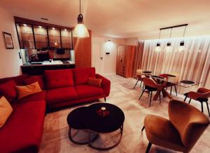 uma sala de estar com um sofá vermelho e uma mesa em Apartament 34 em Ciechanów