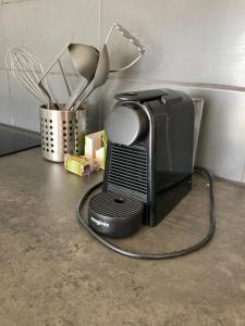 a kitchen counter with a television and some utensils at Landzicht in Woubrugge