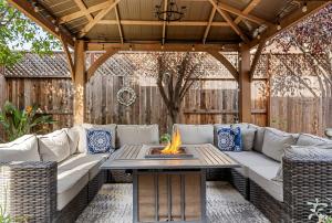 a patio with a couch and a fire pit at Brand New Listing – Windsor “Winetopia” Getaway in Windsor