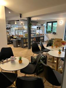 a restaurant with tables and chairs and a kitchen at ALBERGO 900Strati in Bergamo