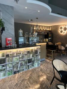 a restaurant with a counter with glass shelves at ALBERGO 900Strati in Bergamo