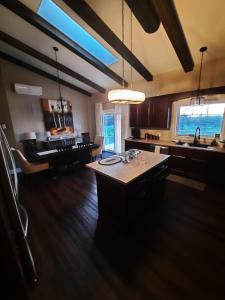 a large kitchen with a island in the middle at Back Home Bed and Breakfast in Membertou