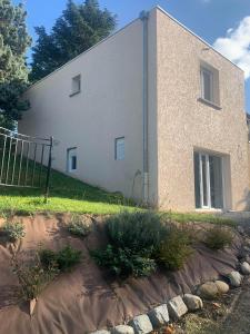 un edificio blanco con una valla delante en LE BRON ACCUEIL - TOPDESTINATION-LYON, en Bron