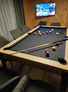 a pool table with balls on top of it at Chata Demian in Demanovska Dolina