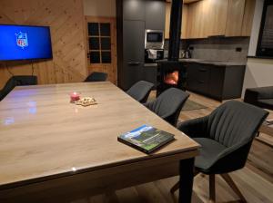 a conference room with a table and a fireplace at Chata Demian in Demanovska Dolina +51 photos
