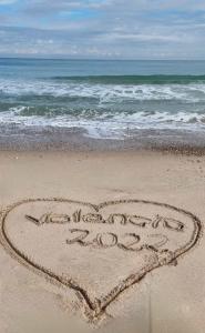 a heart drawn in the sand on the beach at Salamar Saler Golf in El Saler