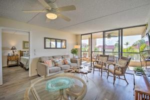 a living room with a couch and a table at Downtown Kona Condo with Pool Access Walk to Beach! in Kailua-Kona