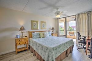 a bedroom with a bed and a desk and a window at Downtown Kona Condo with Pool Access Walk to Beach! in Kailua-Kona +32 photos