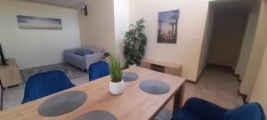 a dining room with a table and blue chairs at Impala Suite -Entire Unit- 2 bedroom with 1 ensuite bathroom in Ladysmith