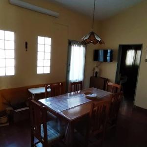 Un comedor con mesa y sillas de madera. en La Candelaria, en Santa Rosa de Calamuchita