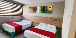 Voodi või voodid majutusasutuse Hotel Murali - Cerca del Aeropuerto de Guayaquil toas