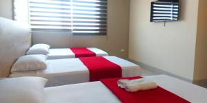 Voodi või voodid majutusasutuse Hotel Murali - Cerca del Aeropuerto de Guayaquil toas