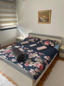 a bedroom with a bed with a cat laying on it at Michel FREE PARKING in Vranje